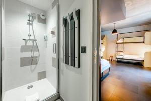 a bathroom with a shower and a glass door at MEININGER Hotel Bordeaux Gare Saint-Jean in Bordeaux