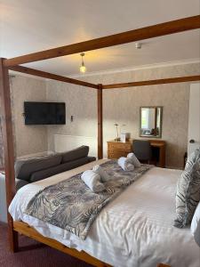 a bedroom with a large bed with two pillows on it at Oriel Hotel in St Asaph