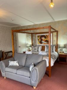 a living room with a couch and a bed at Oriel Hotel in St Asaph