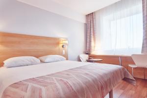 Postel nebo postele na pokoji v ubytování MyContinental Sibiu