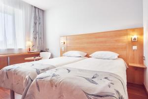 Postel nebo postele na pokoji v ubytování MyContinental Sibiu