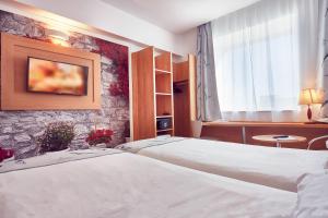 Postel nebo postele na pokoji v ubytování MyContinental Sibiu
