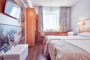 Postel nebo postele na pokoji v ubytování MyContinental Sibiu