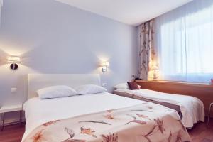 Postel nebo postele na pokoji v ubytování MyContinental Sibiu