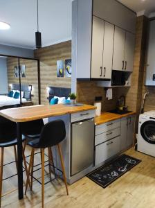 a kitchen with a table and chairs in a room at Apart Club Tolstogo in Chernivtsi +27 photos