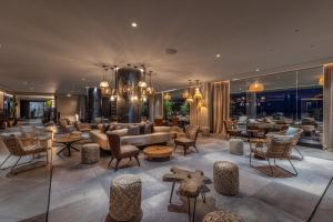 a lobby with a couch and chairs and tables at Hotel Faro, a Lopesan Collection Hotel - Adults Only in Maspalomas