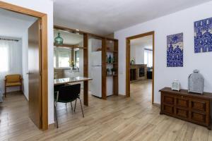 a kitchen and living room with a desk and a table at Adaptados 32 in Vinaròs