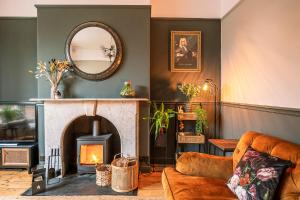 a living room with a fireplace and a mirror at 46 Nunnery Lane in York