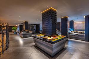 a restaurant with a buffet of food in a building at Hotel Faro, a Lopesan Collection Hotel - Adults Only in Maspalomas
