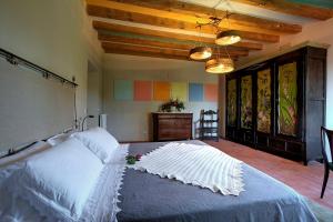 a bedroom with a large white bed in a room at Palazzo Gatteschi in Poppi