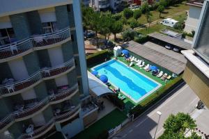 an overhead view of a swimming pool next to a building at Hotel Boston in Alba Adriatica