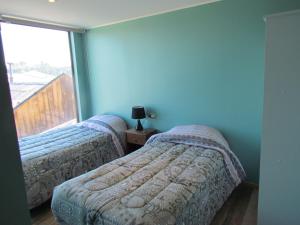 Een bed of bedden in een kamer bij Departamentos San Bruno