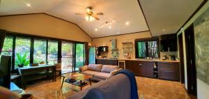 a living room with a couch and a table at UTOPAI Stone Garden Vacation Home, Pai! in Ban Muang Soi