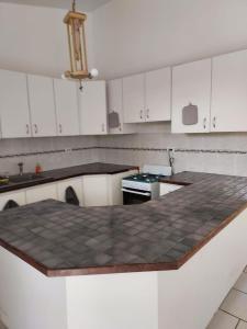 a kitchen with white cabinets and a counter top at confort apto con balcones in Vega Alta