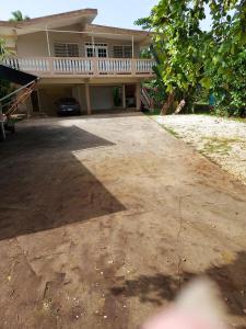 a house with a large driveway in front of it at confort apto con balcones in Vega Alta