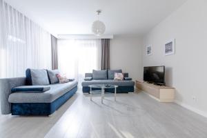 TV a/nebo společenská místnost v ubytování Resort Apartamenty Klifowa Rewal 19