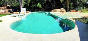 a swimming pool in a yard with a pool at UTOPAI Stone Garden Vacation Home, Pai! in Ban Muang Soi