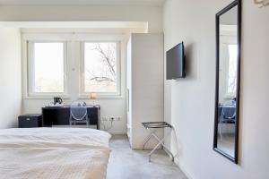 1 dormitorio con cama, escritorio y espejo en Le Vette Room&Breakfast, en Rovereto