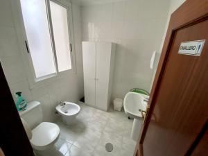 ein kleines Bad mit WC und Waschbecken in der Unterkunft Hostal Alvarez in León
