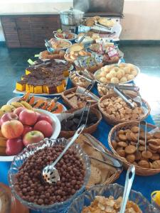 a table topped with lots of different types of food at Hotel Fazenda Bandeirantes in Ibiúna