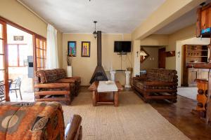 a living room with couches and a table at Gecko Castle in Dullstroom
