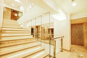 a staircase in a house with glass railing at Hotel Auris in Mumbai