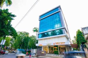 a tall building with blue windows on a city street at Hotel Auris in Mumbai