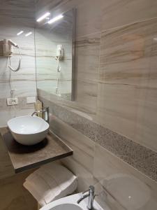 a bathroom with a sink and a toilet and a mirror at Hotel Castello in Venice