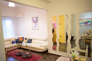 a living room with a white couch and a table at Mary's Apt 2bedrooms in Allou Fun Park West Athens by MK in Piraeus