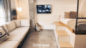 a living room with a couch and a bed at Gook Home BEACH in Málaga