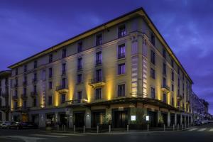 
a large building with a clock on the front of it at WorldHotel Casati 18 in Milan
