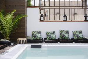 a swimming pool in the middle of a room with at Elite Hotel - Gay Men Only in Sitges
