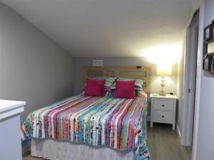 a bedroom with a bed with two pink pillows at Our Happy Place in Destin