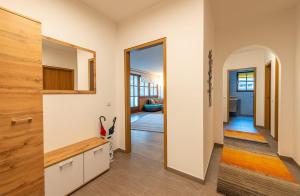 a kitchen with white cabinets and a hallway at Ferienwohnung Kogelblick in Ebensee