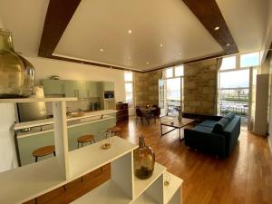 a kitchen and living room with a couch and a table at - Le Saugeron - in Blaye