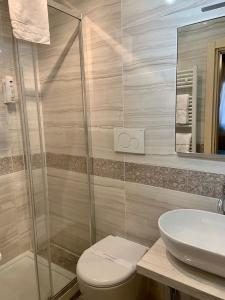 a bathroom with a shower and a toilet and a sink at Hotel Castello in Venice