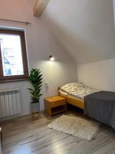 a small bedroom with a bed and a window at Domek MAYA Górska Chata in Białka Tatrzańska