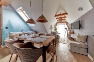 a dining room with a table and chairs at Tatra Square Apartments in Zakopane