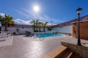 a patio with a pool and a table and chairs at Hotel Boutique Sibarys - Adults Recommended in Nerja