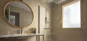 a bathroom with a shower and a sink and a mirror at Hotel Chambord in Menton