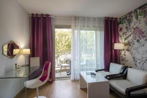 a living room with a couch and a table at Hotel Chambord in Menton