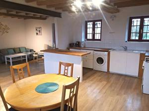 a kitchen with a wooden table and a kitchen with a dining room at Maison de charme entre ville et campagne in Amilly