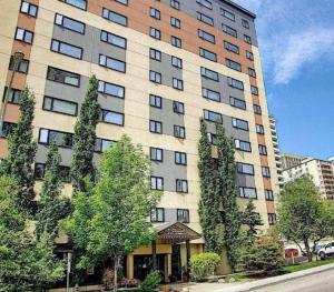 a large building with trees in front of it at Downtown River Valley Bachelor Suite Condo, NON Smoking, 12 inches Queen Bed, Beautiful Minimalist, very convenient every where in Edmonton