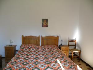 a bedroom with a bed and a picture on the wall at Case Vacanze Valdilago in Bolsena