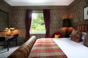 a hotel room with a bed and a window at Cameron House on Loch Lomond in Balloch