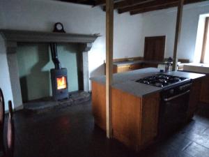 a kitchen with a stove and a stove top oven at Gite de puy faucher in Arrènes