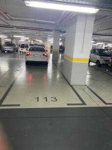 a car is parked in a parking garage at Apartment Azzurro lux in Novi Beograd