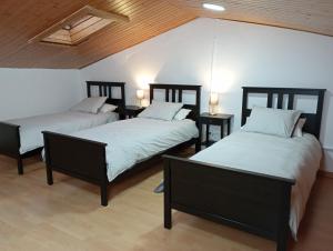 two beds in a room with two tables at House near Barcelona/F1 circuit in Montmeló