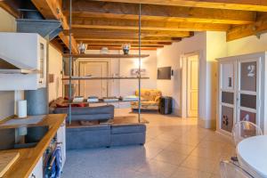 a kitchen with wooden ceilings and a living room at Youatmolino Canal View Apartment in Venice