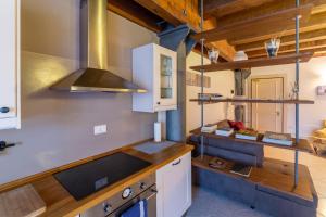 a kitchen with a sink and a stove top oven at Youatmolino Canal View Apartment in Venice